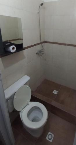 a small bathroom with a toilet and a sink at Esquina La Argentina in San Luis