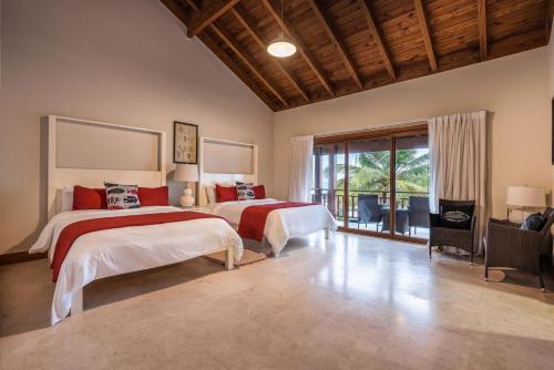 a bedroom with two beds and a balcony at Marina Front Villa at Puerto Bahía -Breakfast incl in Santa Bárbara de Samaná