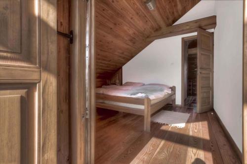 a small bedroom with a bed in a attic at Holiday home in Smiljan 17134 in Smiljan