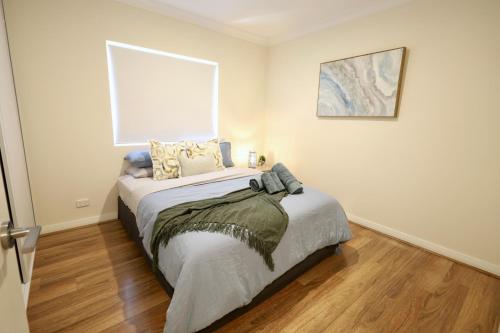 a bedroom with a bed and a picture on the wall at 10 Prime Location Living Midland 1br 1bth - SUPERHOG REQUIRED in Bellevue