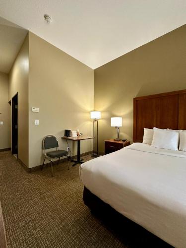 a hotel room with a large bed and a desk at Comfort Inn Ogden near Event Center in Ogden