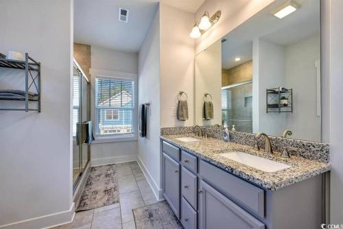 a bathroom with two sinks and a large mirror at Brand New Home 3 Bed 25 bath, 4min walk to beach in Myrtle Beach