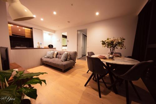 a living room with a table and a couch at New Year eve’s Fireworks & BayView Apt in CBD in Melbourne