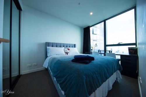 a bedroom with a large bed with a blue light at New Year eve’s Fireworks & BayView Apt in CBD in Melbourne