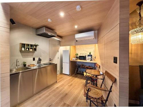 a kitchen with a table and chairs in a room at villa福座 in Furusan
