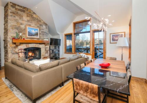 a living room with a couch and a fireplace at Beaver Creek Landing A406 condo in Avon