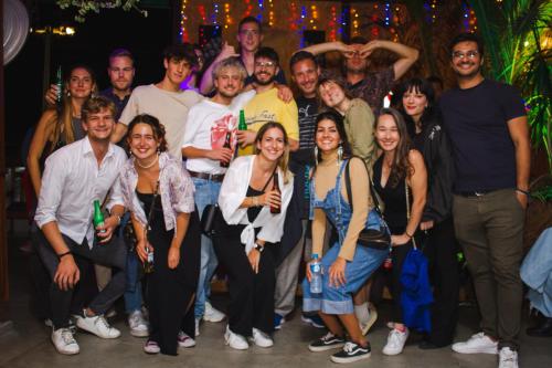 a group of people posing for a picture at a party at Tucano House in Florianópolis
