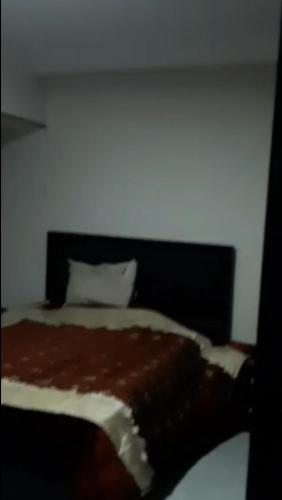 a bedroom with a bed with a black headboard at NaserCity، Star in Cairo