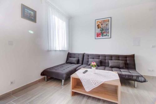 a living room with a couch and a table at Apartment in Cunski - Insel Losinj 15045 in Cunski