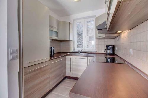 a kitchen with wooden cabinets and a counter top at Apartment in Cunski - Insel Losinj 15045 in Cunski