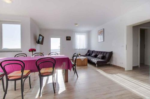 a living room with a table and chairs and a couch at Apartment in Cunski - Insel Losinj 15045 in Cunski