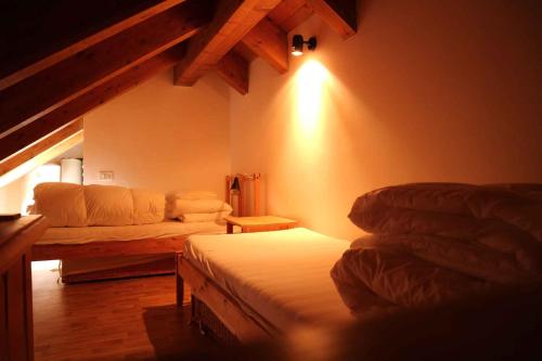 a living room with two beds and a couch at Apartment in Passo Rolle/Südtirol 23444 in Passo Rolle
