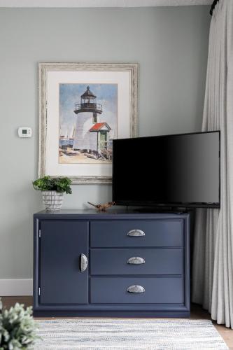 a blue dresser with a tv on top of it at The Shores in Williamsburg