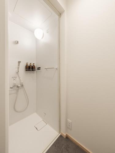 a shower with a glass door in a bathroom at HATAYA - Guesthouse - Private Stay - in Kyotango