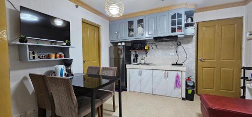 a kitchen with a table and a yellow door at ENTIRE 2BR CONDO UNIT@8 SPATIAL CONDOMINIUM in Davao City