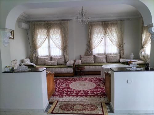 - un salon avec un canapé et une table dans l'établissement Villa Pierrette Casablanca, à Casablanca