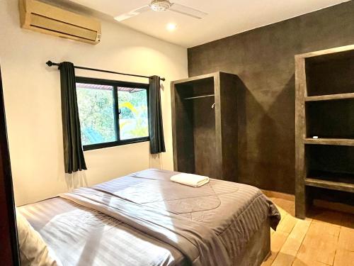 a bedroom with a bed and a window in it at Prana Hotel in Siem Reap