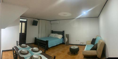 a small living room with a bed and a couch at SilvaMar in Puntarenas