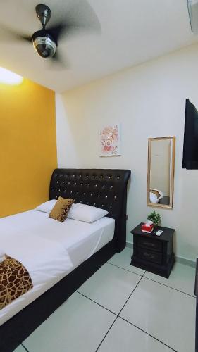 a bedroom with a bed and a mirror at Mimilala Hotel @ i-City, Shah Alam in Shah Alam