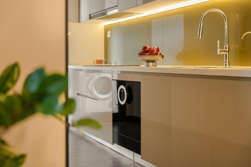 a kitchen with a washer and dryer under a sink at The Matrix One by 1 Le Quang Dao in Hanoi