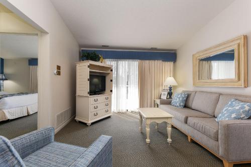 a living room with a couch and a tv at The Shores in Williamsburg