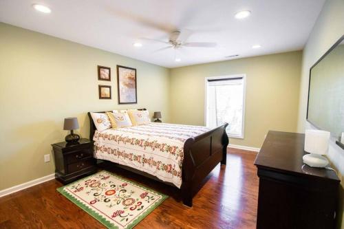 a bedroom with a bed and a table and a tv at Charming Apartment on Oak in Cookeville