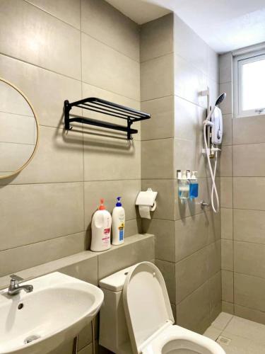 a bathroom with a toilet and a sink and a mirror at JOVIAL Modern Cozy Suite `Metropol BM BandarPerda in Bukit Mertajam