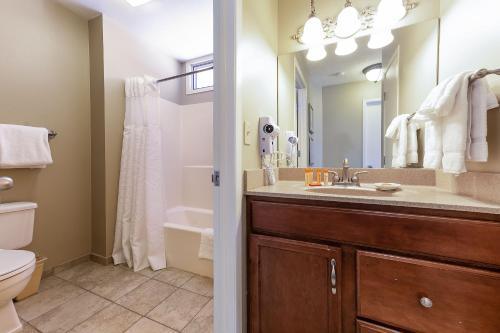 a bathroom with a sink and a toilet and a mirror at The Shores in Williamsburg