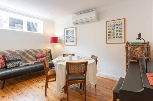 a living room with a table and a couch at Sydney -Cammeray apartment in Sydney