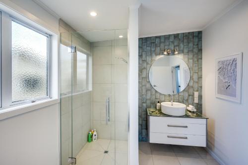 a bathroom with a shower and a sink and a mirror at Serenity by the Sea - Haumoana Beach Holiday Home in Haumoana
