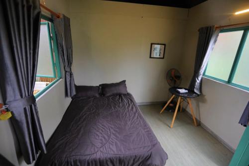 Ένα ή περισσότερα κρεβάτια σε δωμάτιο στο Chamlam home stay and coffe