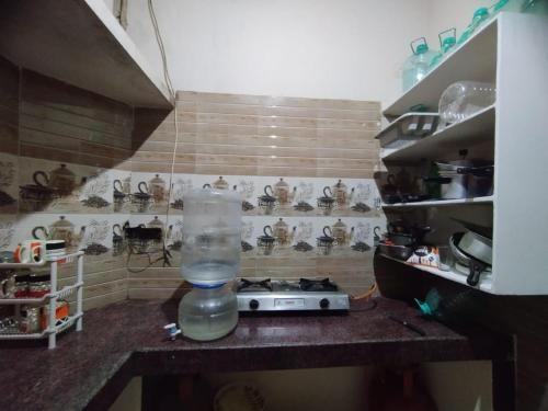 a kitchen with a plastic container on a counter at Dumzy's Tombs View in Hyderabad