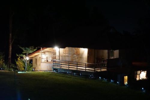 a house lit up at night with lights at Tafelberg detached bungalow with swimming pool in Chiang Rai