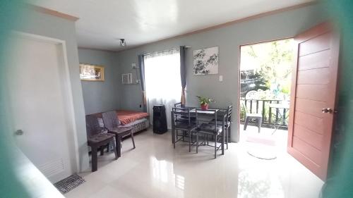 a living room with a table and a dining room at BOHOL Simple and Elegant Furnished Studio in Tagbilaran City
