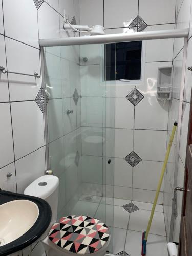 a bathroom with a shower with a toilet and a sink at Apartamento do Walisson in Guaramiranga