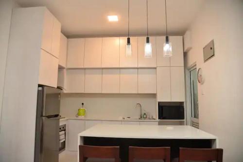 a kitchen with white cabinets and a counter top at Cozy 2 bed 1 bath Apartment for rent in Homagama