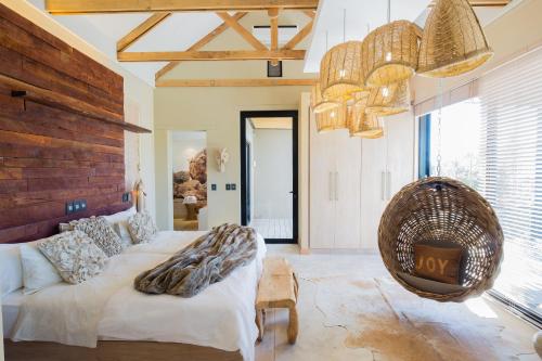 a living room with a couch and a large window at The Olive Exclusive All-Suite Hotel in Windhoek