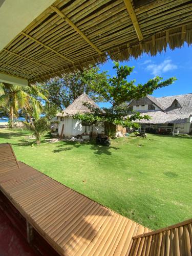 - une vue depuis la terrasse couverte d'une maison avec une cour dans l'établissement Pacific Surf and Yoga, à Baras