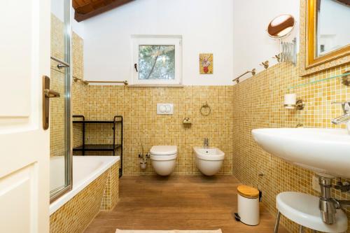a bathroom with two toilets and a sink at STONE HOUSE reTREAT in Mali Lošinj