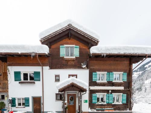 a house with snow on the roof at Apartment in Vorarlberg near Ski Resort Montafon in Sankt Gallenkirch