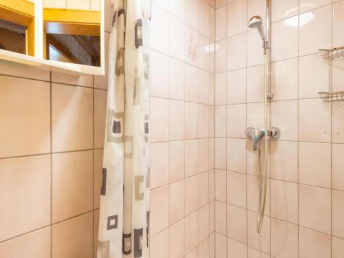 La salle de bains est pourvue d'une douche avec rideau de douche. dans l'établissement Comfortable house with garden in Voralberg, à Sankt Gallenkirch