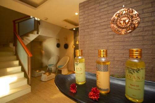 two bottles sitting on a table in a room at Yog Wellness Resort & Spa By Amritara in Mussoorie