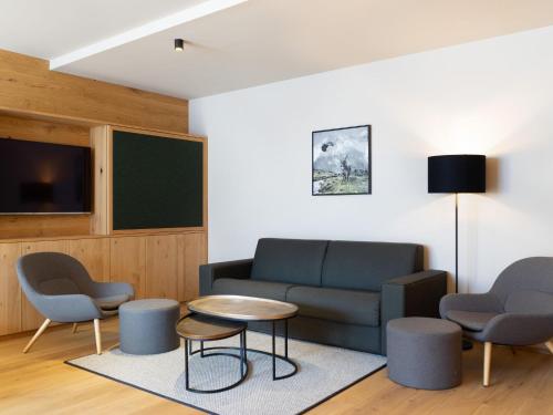 a living room with a couch and chairs and a table at Apartment in Schröcken near Ski Arlberg in Schröcken