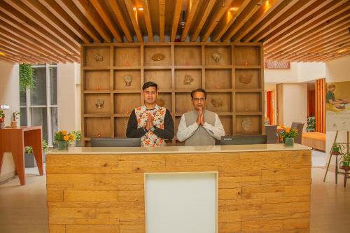 two men standing at a counter in a room at Yog Wellness Resort & Spa By Amritara in Mussoorie