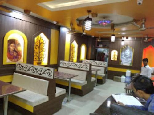 a restaurant with chairs and tables in a room at Hotel Rajawat , Madhya Pradesh in Vidisha