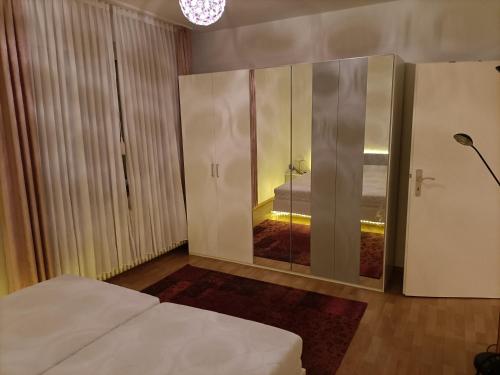 a bedroom with a bed and a sliding glass door at Double room in Bielefeld