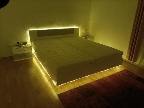 a bedroom with a bed with a light on it at Double room in Bielefeld