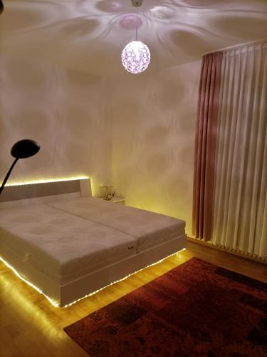 a bedroom with a bed with a lamp and a window at Double room in Bielefeld