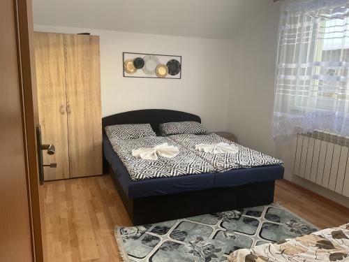 a small bedroom with a bed and a window at Homestay Renata in Nová Lesná