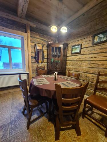 a dining room with a table and chairs at Zirgu sēta "Klajumi" - Horse ranch "Klajumi" in Kaplava